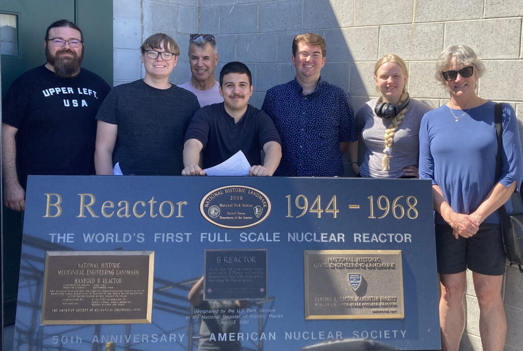 Photo of EWU history students and Professor Ann LeBar standing behind the Hanford Historical Landmark sign.