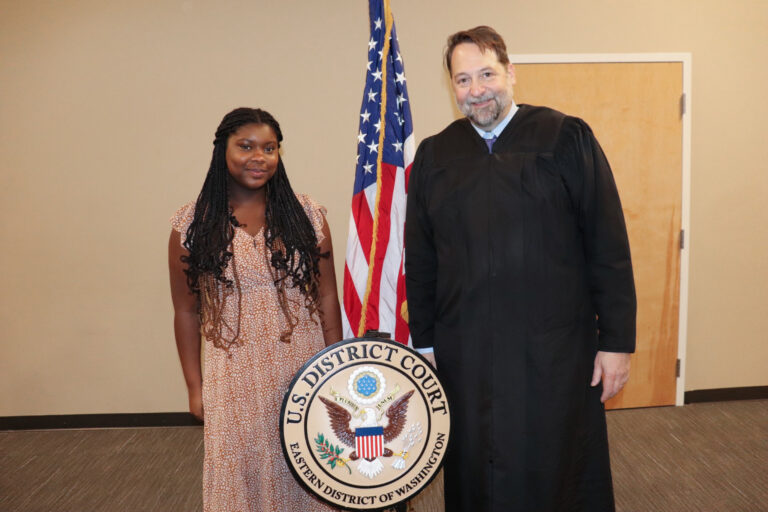EWU student vocalist Za'Kayla Jones standing with a U.S. District Court judge.