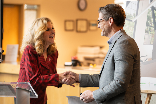 EWU President Shari McMahan shakes hands with Delta Dental of Washington CEO Mark Mitchke.