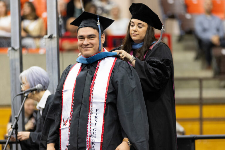 Eric Corona, a graduate student, getting his stole.