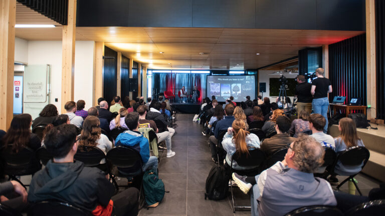 crowd seated watching speaker