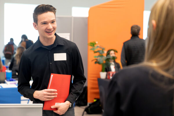Young person holding a folder for an interview.