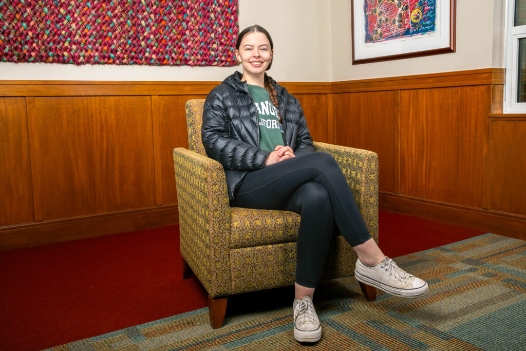 Business major Lucy Bowers sitting in a chair