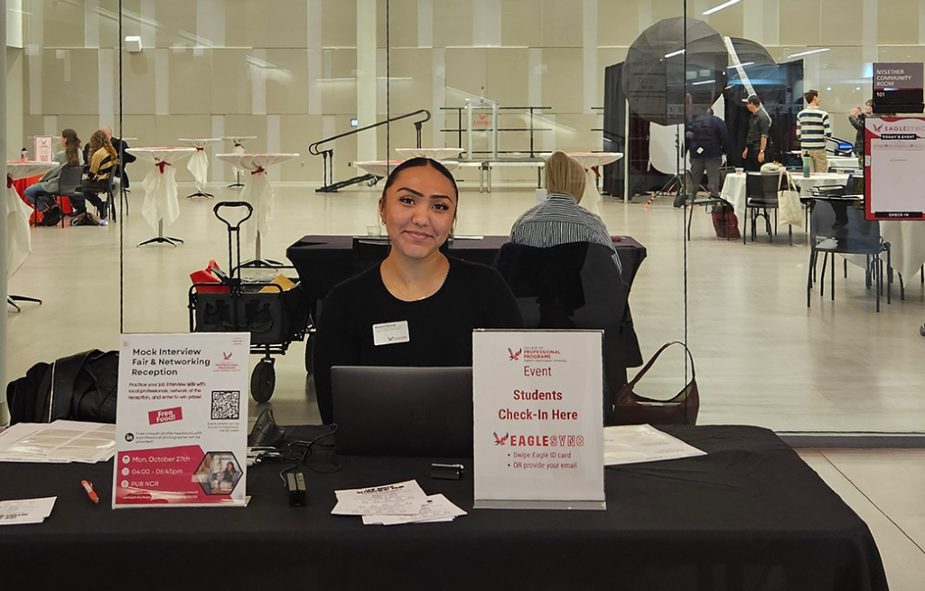 Photo of greeter at entry table at the 2025 Mock Career Fair.