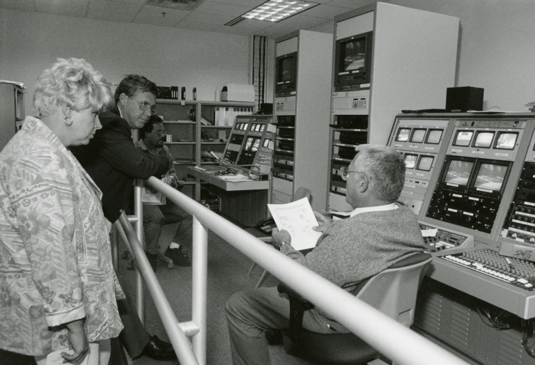 Black and white photo of faculty with large computer system.