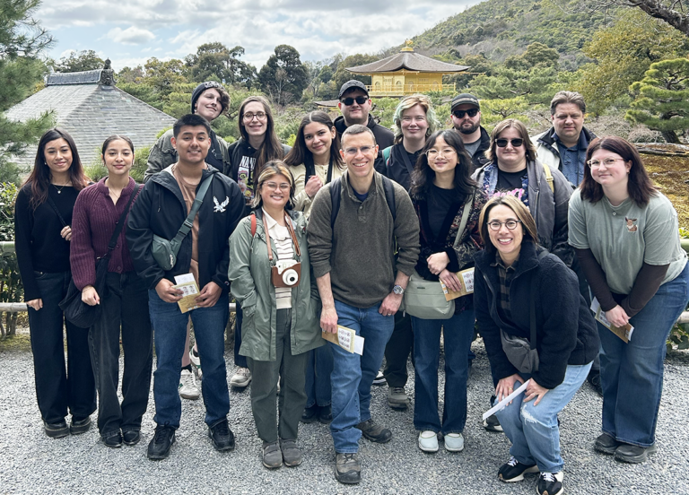 Photo of students and instructors who traveled to Japan with an interesting building in the background.