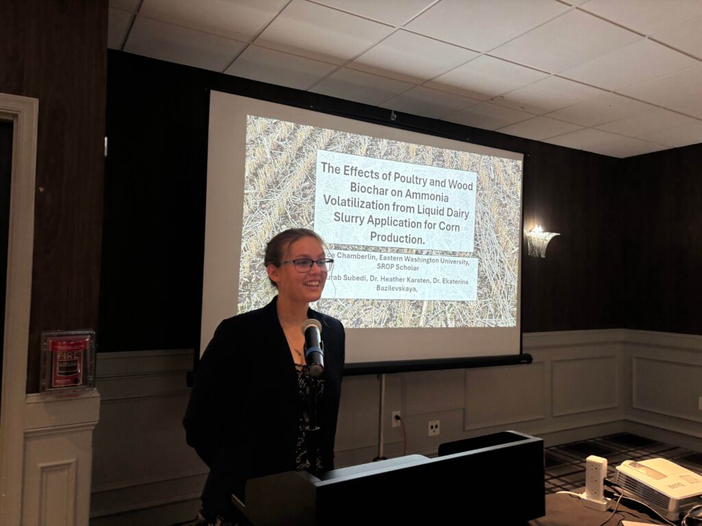 Alice Chamberlin presents from podium at conference.