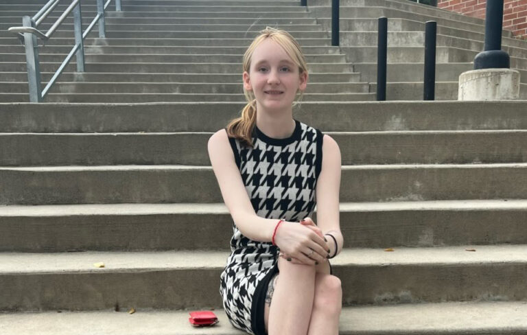 Photo of Devyn Britton sitting on steps.