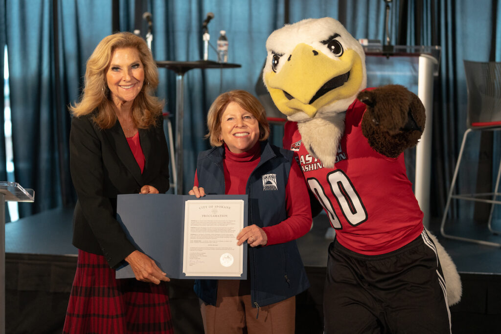 Photo of Shari McMahan, Lisa Brown and Swoop with mayoral proclamation.