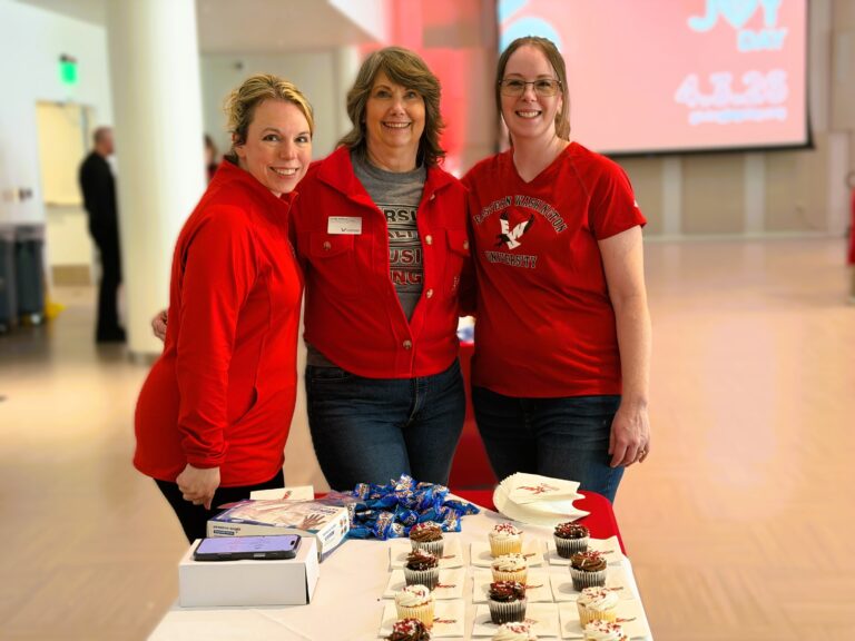 Photo of three women from the fundraising team with cupcakes.