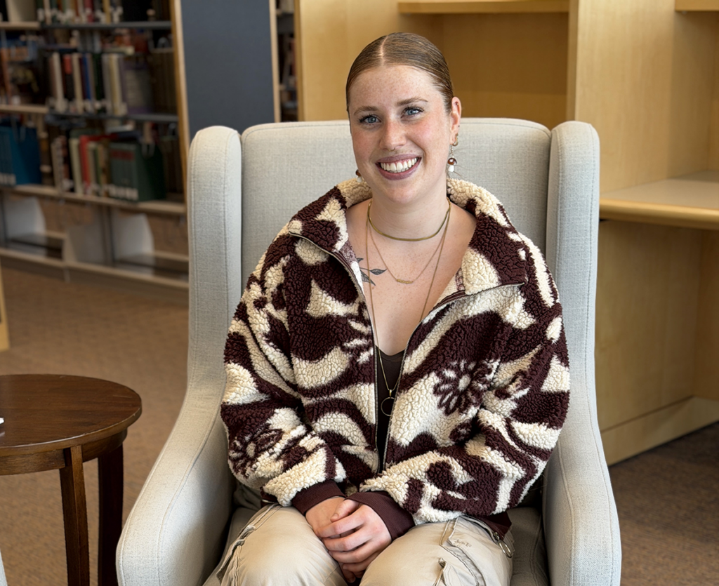 Photo of Mikala Thomason sitting in a chair at JFK Library.