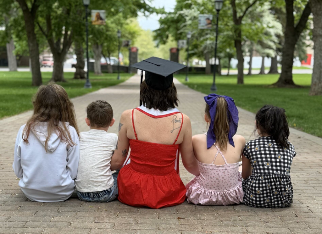 Clemons and her children sitting on the Hello Walk and looking at the pillars recently.