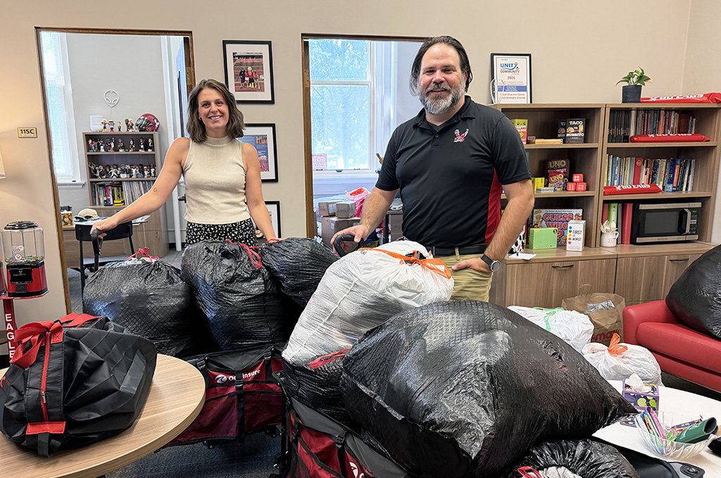 Mark Este and Jasmin Davis with bags of donated clothing.