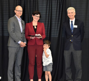 Photo of Catherine Girard receiving her Excellence Award from Dean's Brian Donahue and Pete Porter